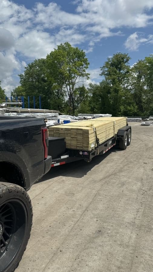 Lumber load strapped to the car hauler trailer