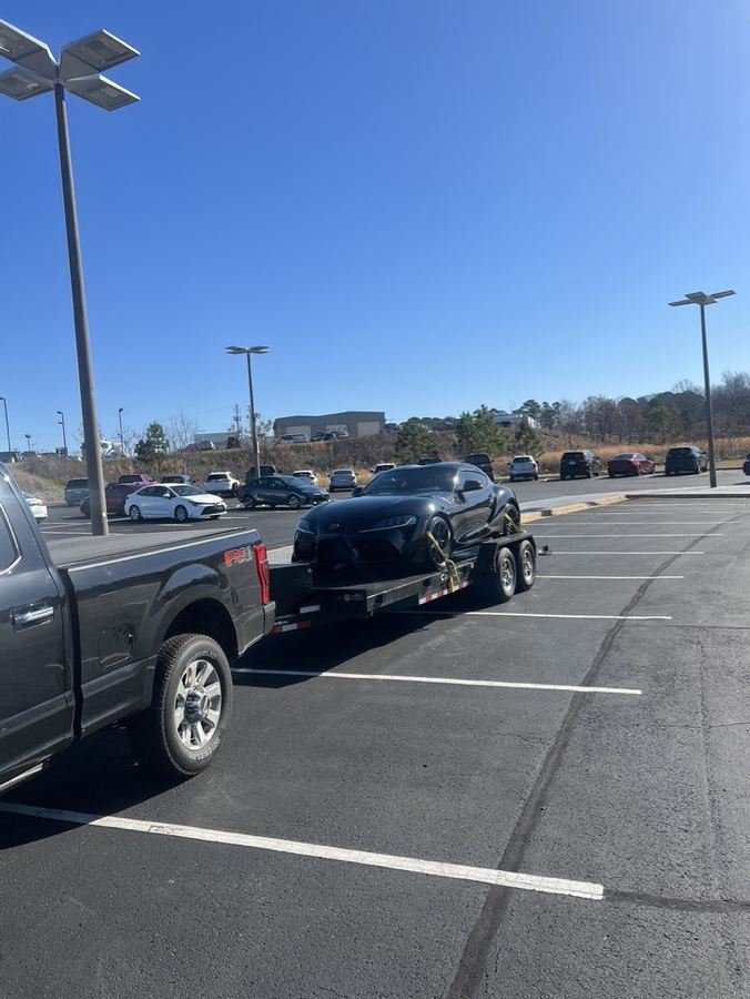 Sports car loaded on the car hauler trailer